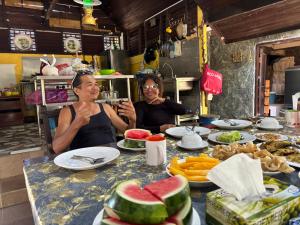 two women sitting at a table with food at Gio Private Villa - Langkawi in Langkawi Intl +27 photos