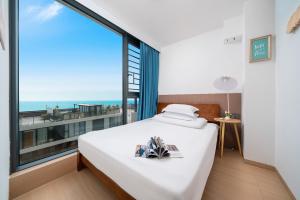 a bedroom with a bed and a large window at Man Man hotel in Wutongkeng