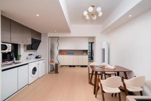 a kitchen and dining room with a table and chairs at Man Man hotel in Wutongkeng +21 photos