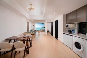 a kitchen and living room with a table and chairs at Man Man hotel in Wutongkeng