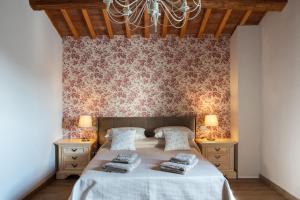 a bedroom with a large bed with two night stands at Fienile in Pontassieve +15 photos