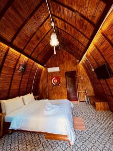 a bedroom with a large bed in a wooden ceiling at Cicada Lanta in Ko Lanta
