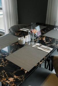 a dining room table with two tables with place mats at Hotel Residence at Novotel in Manila