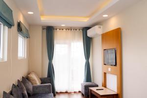 a living room with a couch and a window at Marlo Hotels in Kathmandu