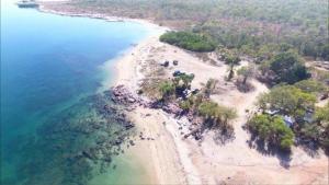 an aerial view of a beach with trees and water at Coconut Lodge in Kalumburu