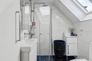a white bathroom with a shower and a sink at Hambo Stay in Staffanstorp +21 photos