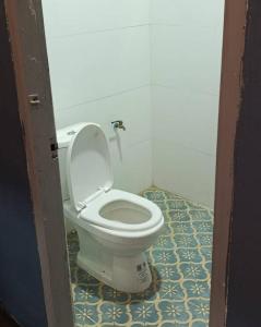 a bathroom with a white toilet in a room at Bokeo Social and Eatery in Ban Fay
