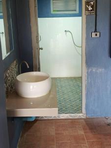 a bathroom with a white tub and a shower at Bokeo Social and Eatery in Ban Fay