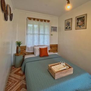 a bedroom with a bed with a tray on it at Casa de Myra in Palayan City
