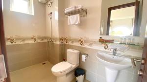 a bathroom with a toilet and a sink at Lộc Phú Villa - Hoanglee in Da Lat +28 photos