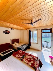 a bedroom with a bed and a wooden ceiling at The HIGHLIGHT STAY in Uttarkāshi