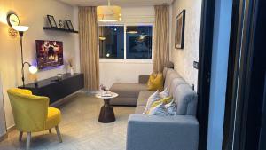a living room with a couch and a chair at Ramo house Central Comfort with Views in Chefchaouen