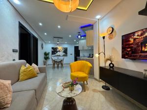 a living room with a couch and a yellow chair at Ramo house Central Comfort with Views in Chefchaouen