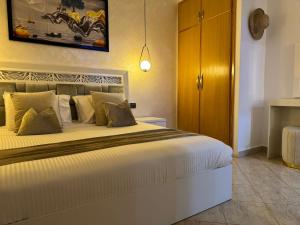 a bedroom with a large white bed in a room at Ramo house Central Comfort with Views in Chefchaouen