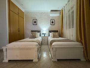 two beds sitting in a room with at Ramo house Central Comfort with Views in Chefchaouen
