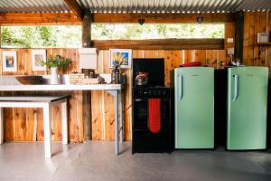 a kitchen with two refridgerators and a table and a counter at HighlandsView in Swellendam +50 photos