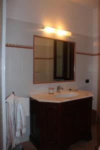 a bathroom with a sink and a mirror at La Piazzetta in Bettona +22 photos