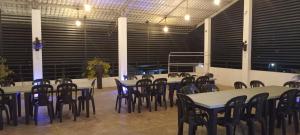 a group of tables and chairs in a large room at Rohan's Residence in Kandana