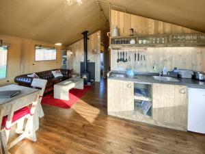 a kitchen and living room with a couch and a table at Pheasant Lodge in Pangbourne