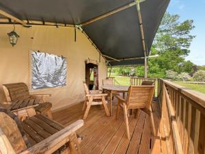 a wooden deck with a table and chairs on it at Pheasant Lodge in Pangbourne +14 photos