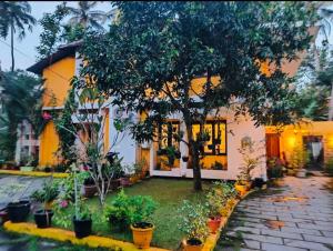 a house with trees and plants in front of it at The Boho Inn in Cochin