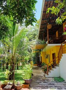 a courtyard of a house with trees and plants at The Boho Inn in Cochin +33 photos