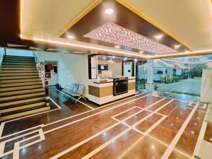 a living room with a staircase and a stair case at Hotel Laxmi villa in Naini