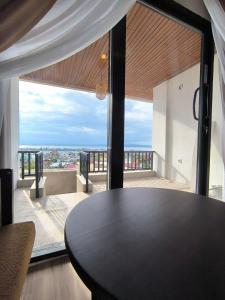 a table in a room with a view of a balcony at Wisma SIDAPORE JD in Lamobuang