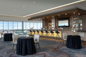 a restaurant with tables and chairs and a bar at Renaissance Dallas Hotel in Dallas