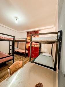 a room with three bunk beds and a table at Kandy Golden Gate Resort in Kandy +41 photos