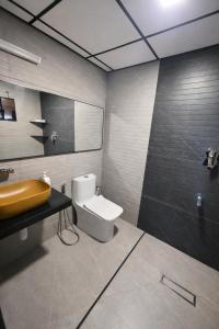 a bathroom with a sink and a toilet in it at TAM BoSa Beach Retreat in Kalyānpur