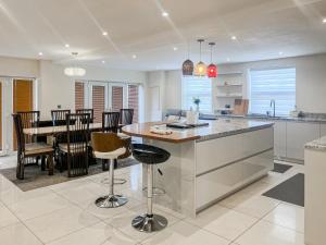 a kitchen and dining room with a table and chairs at Gokula House in Cockermouth