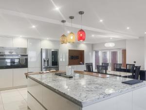 a kitchen with a counter top and a kitchen island at Gokula House in Cockermouth
