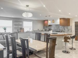 a kitchen and dining room with a table and chairs at Gokula House in Cockermouth +17 photos