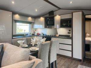 a kitchen with a table and chairs in a kitchen at Herdwick Lodge - Uk51383 in Westward