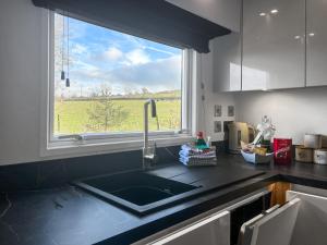 a kitchen counter with a sink and a window at Herdwick Lodge - Uk51383 in Westward
