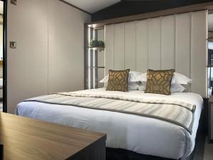 a bedroom with a large bed in a room at Herdwick Lodge - Uk51383 in Westward +7 photos