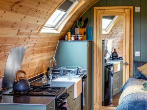 a kitchen with a stove and a sink in a cabin at Curlew - Uk51340 in Draughton