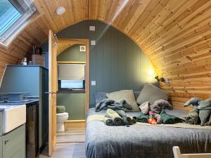 a room with a bed with stuffed animals on it at Curlew - Uk51340 in Draughton +15 photos