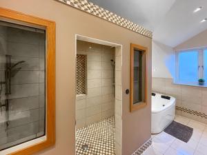 a bathroom with a shower and a toilet and a tub at The Wendover in Rowen +3 photos