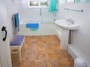 a bathroom with a sink and a bath tub and a sink at The Barley Mow in Kirkoswald +14 photos