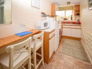 a small kitchen with a counter and a microwave at The Barley Mow in Kirkoswald