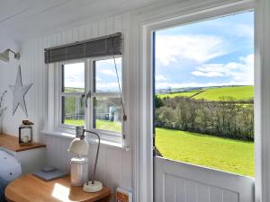 a window with a view of a green field at Pip's Hut in Bideford