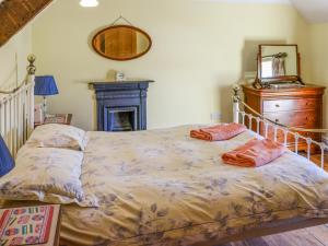 a bed with two pillows on it in a bedroom at The Cottage in Broad Haven