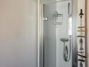 a glass door to a shower in a room at The Cottage in Broad Haven +3 photos