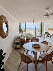 a living room with a table and chairs at Vitamin Sea - Gold Coast luxury on the lagoon in Gold Coast