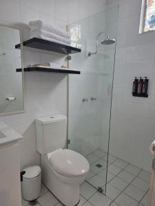 a white bathroom with a toilet and a shower at Nebula Motel in Cooma +22 photos
