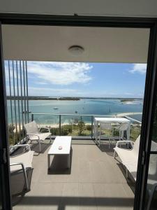 a balcony with chairs and a view of the ocean at Vitamin Sea - Gold Coast luxury on the lagoon in Gold Coast
