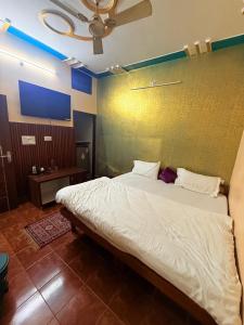 a bedroom with a large bed in a room at Himalayan Stayz in Rishīkesh +2 photos