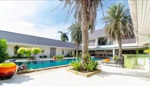 an exterior view of a house with a swimming pool at Baan Katthaliya in Hua Hin